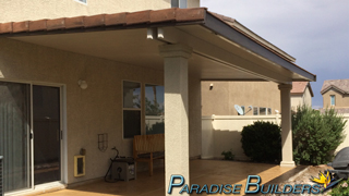 An insulated patio cover with stucco posts and tile trim in a north las vegas backyard